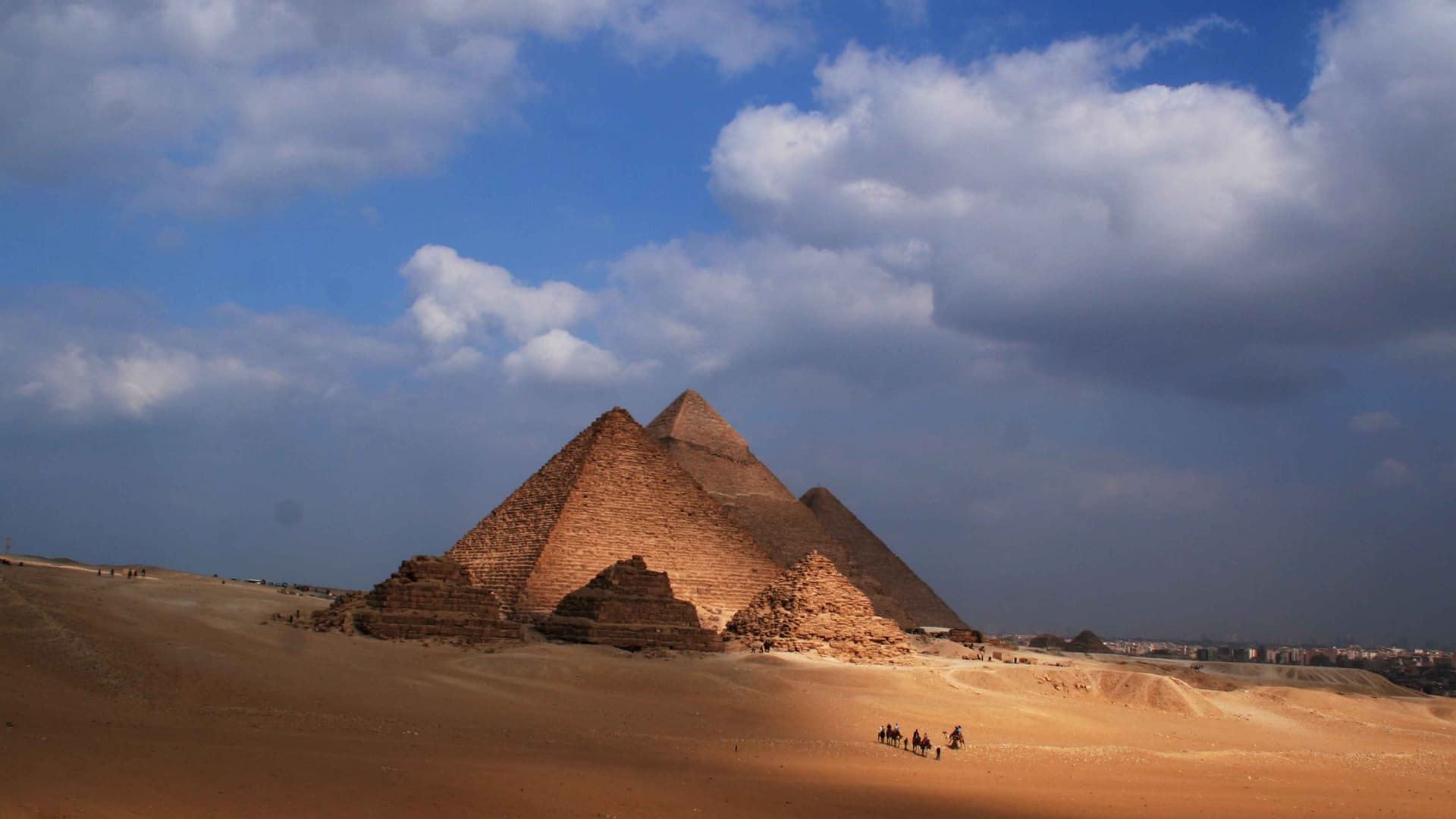 A desert with egyptian pyramids.  